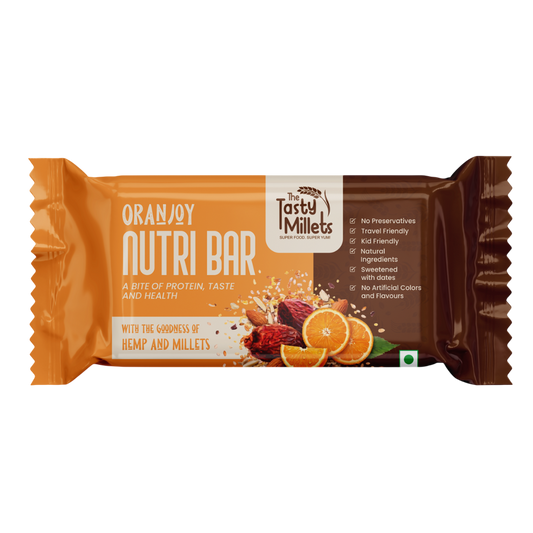 A wrapped protein nutri bar in orange and brown packaging with illustrations of dried herbs, hemp seeds, and orange slices. The brand 'The Tasty Millets' is visible on the front.