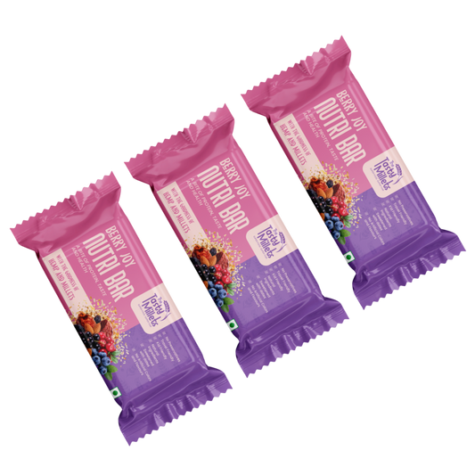 Three wrapped Nutri Bar fruit bars in a berry flavor, arranged diagonally on a plain white background. The packaging features a vibrant pink-to-purple gradient with illustrations of mixed berries and the brand name 'Freshly Picked'.