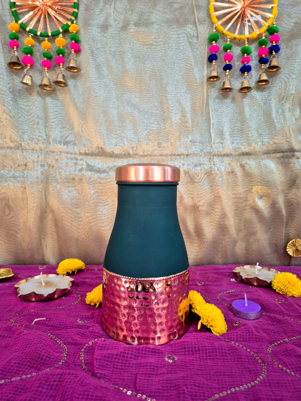 A Single dark teal glass bottle for a Festive gift Hamper 
