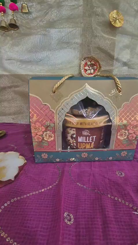 A Single dark teal glass bottle for a Festive gift Hamper which comes with millet upma nutribars